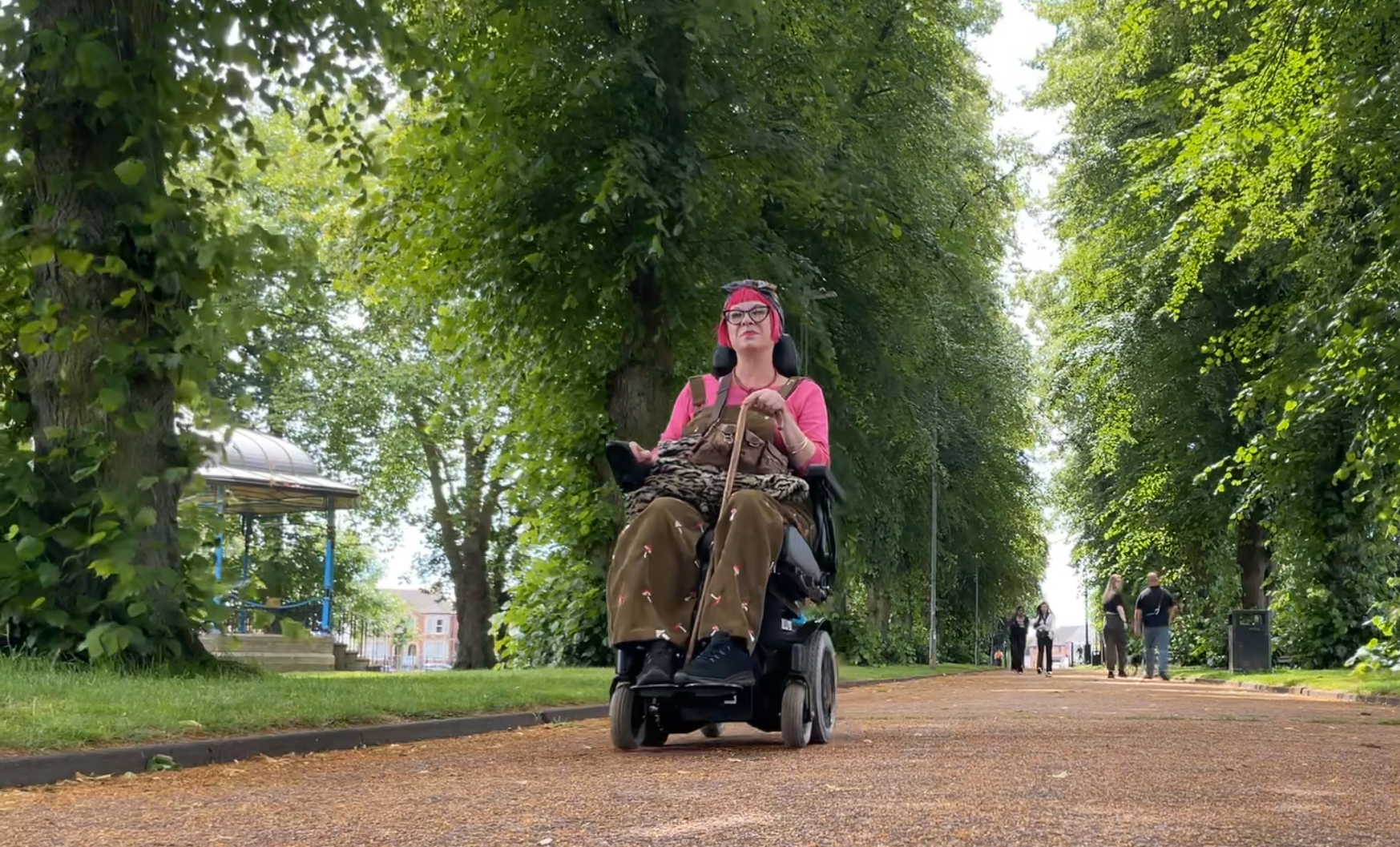 Power chair user in park low view