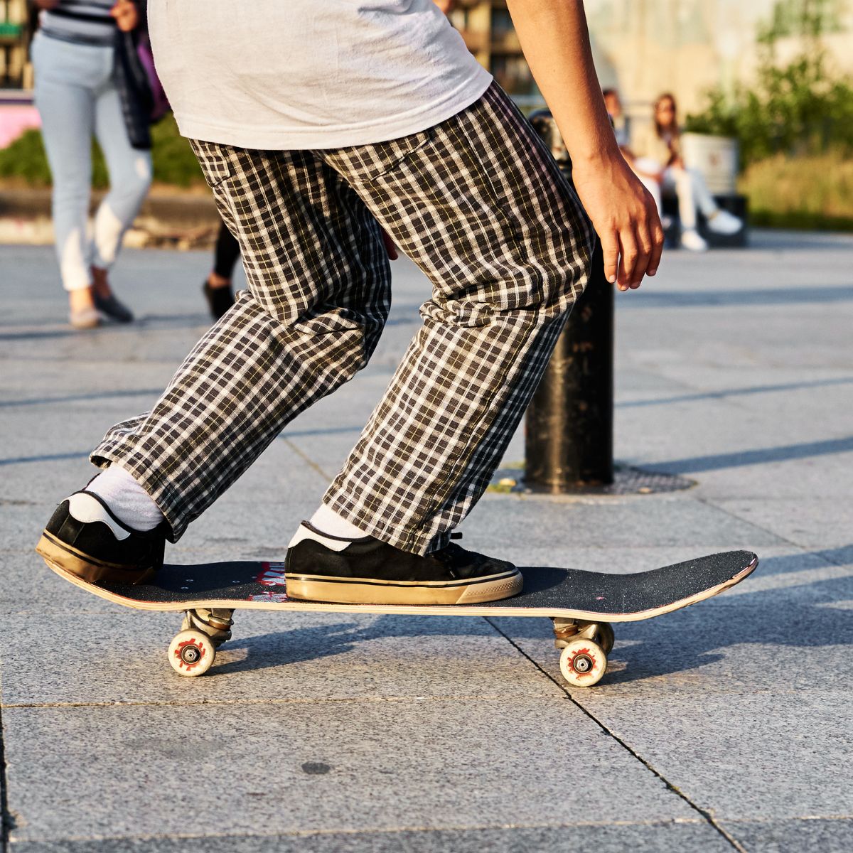 Skateboarder with people in the background