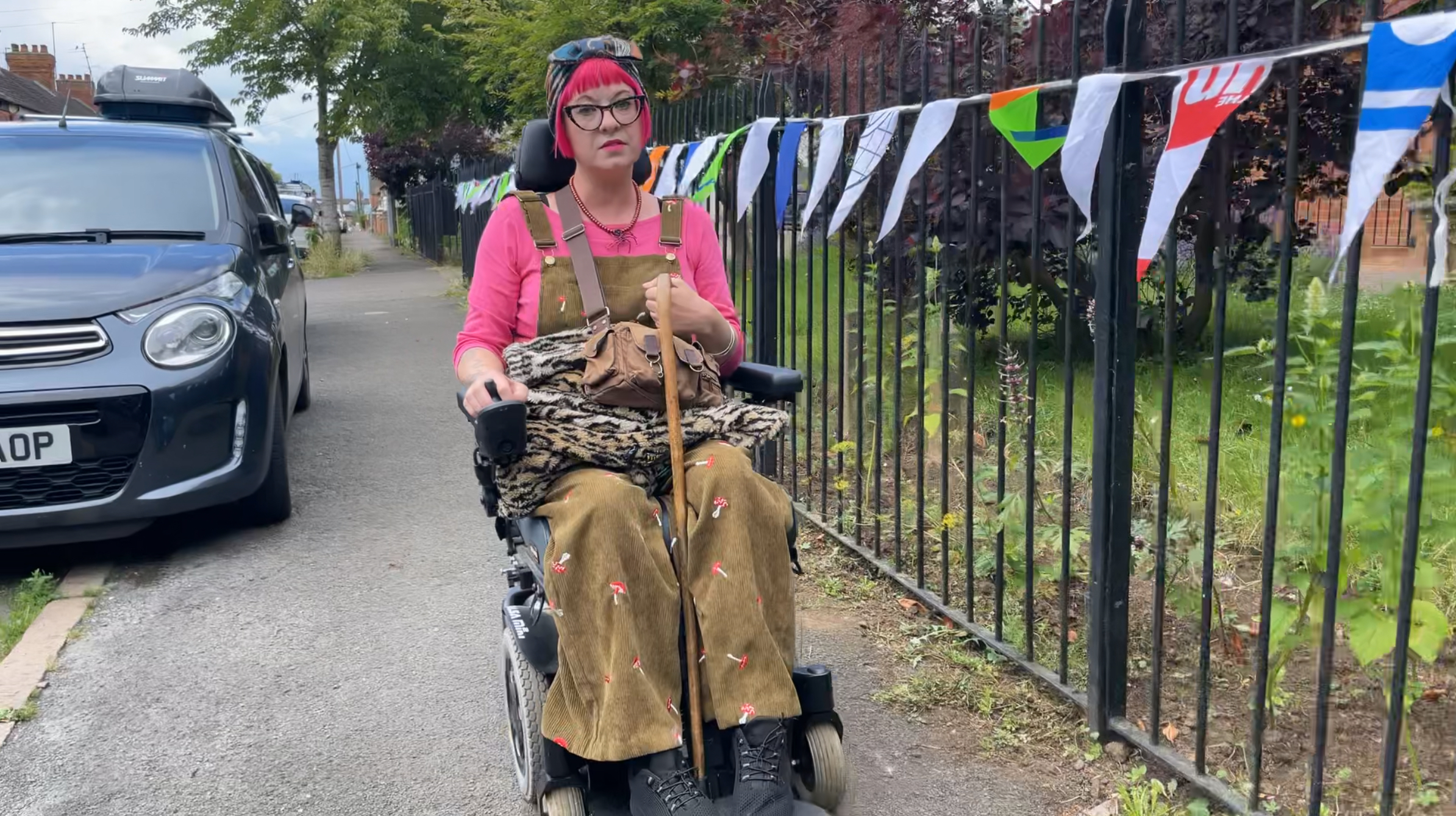 Power chair user on pavement next to bunting