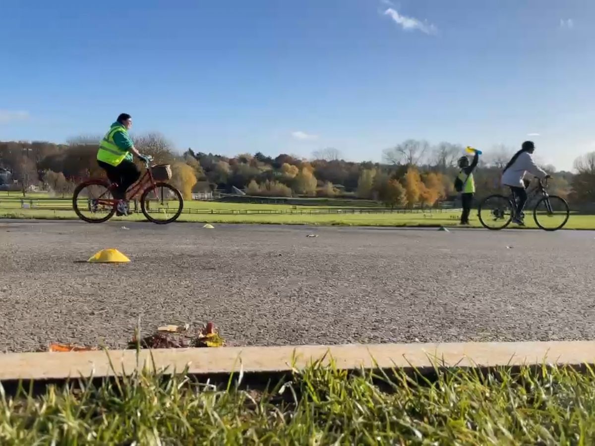 2 cyclist and a cycle trainer on a sunny day
