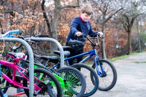 Kid taking his bicycle.